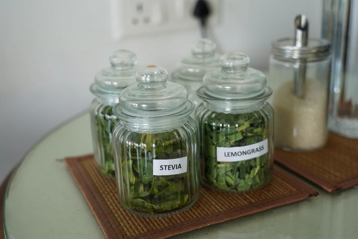 Glass jars of dried Stevia and Lemongrass leaves from the Herbal Garden