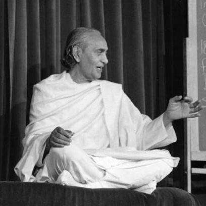 H.H. Dr. Swami Rama of the Himalayas, seated cross-legged and teaching beside a blackboard